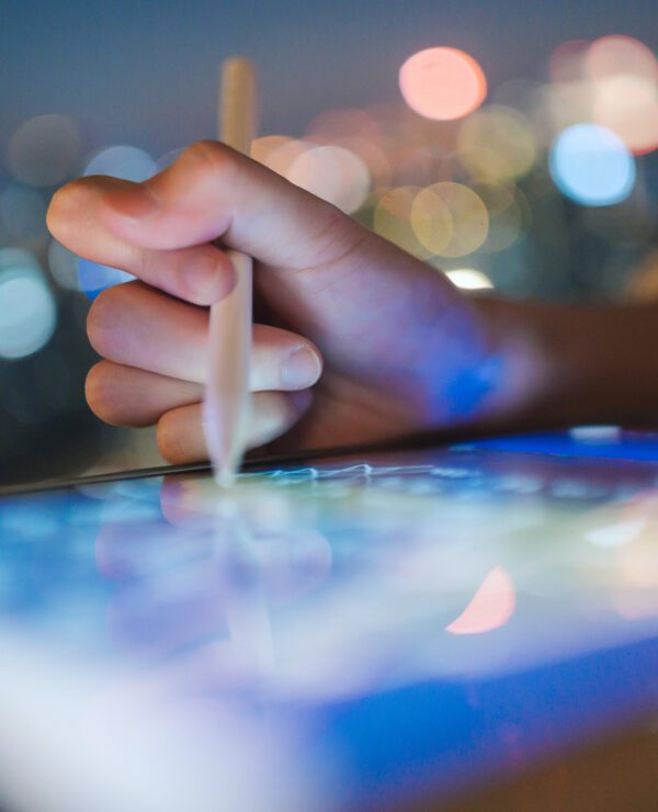 Hand writing on a digital graphics tablet with an electronic pen.