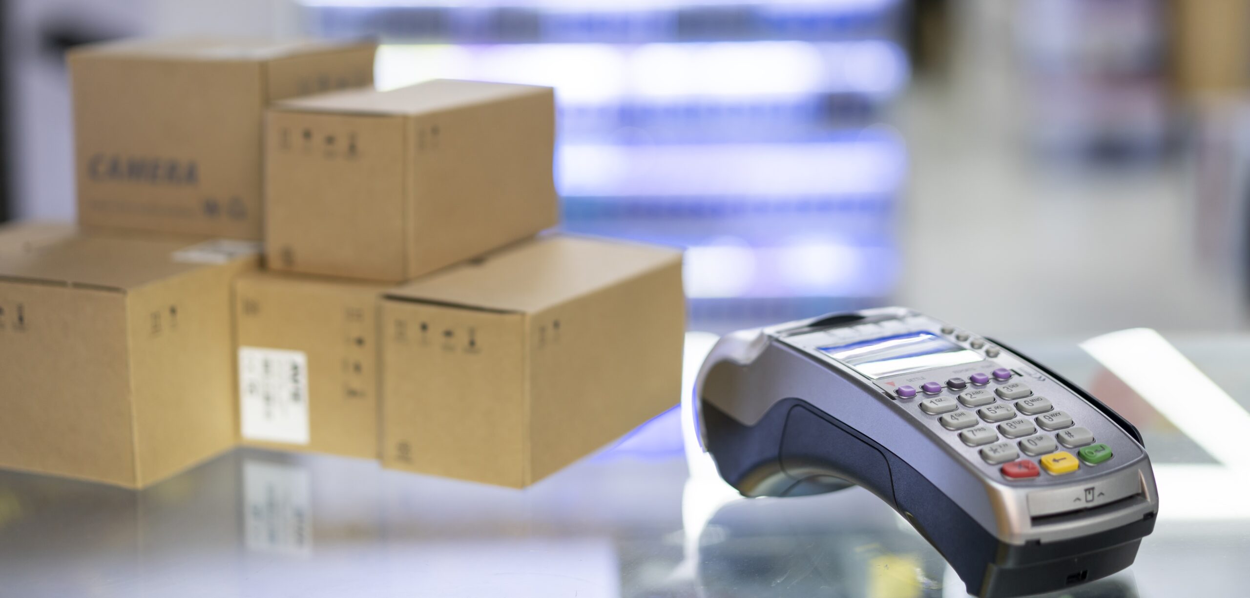 boxes sitting beside a hand-held card-reader for collecting card payments.