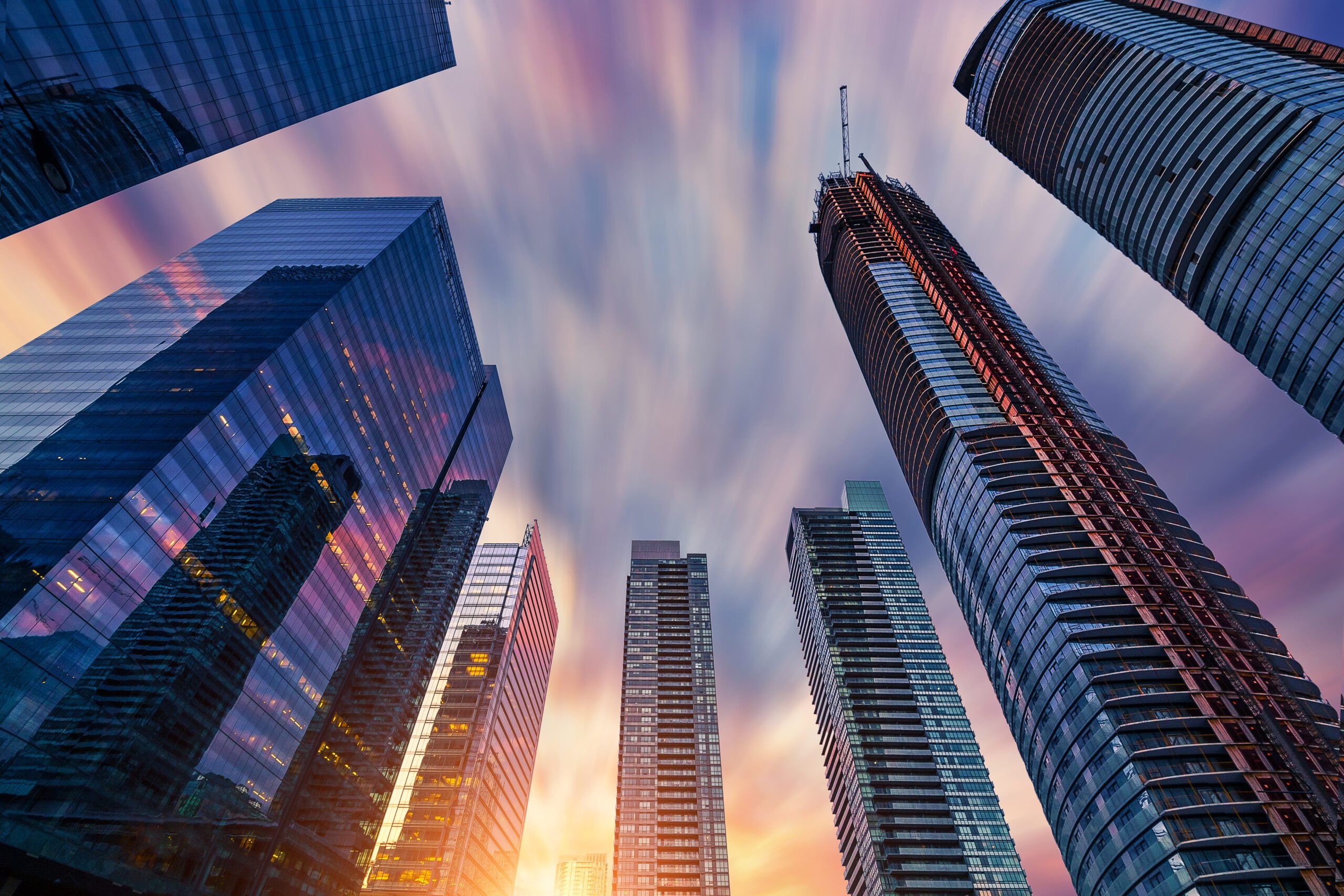 Tall buildings with a beautiful silky cloud texture in the sky